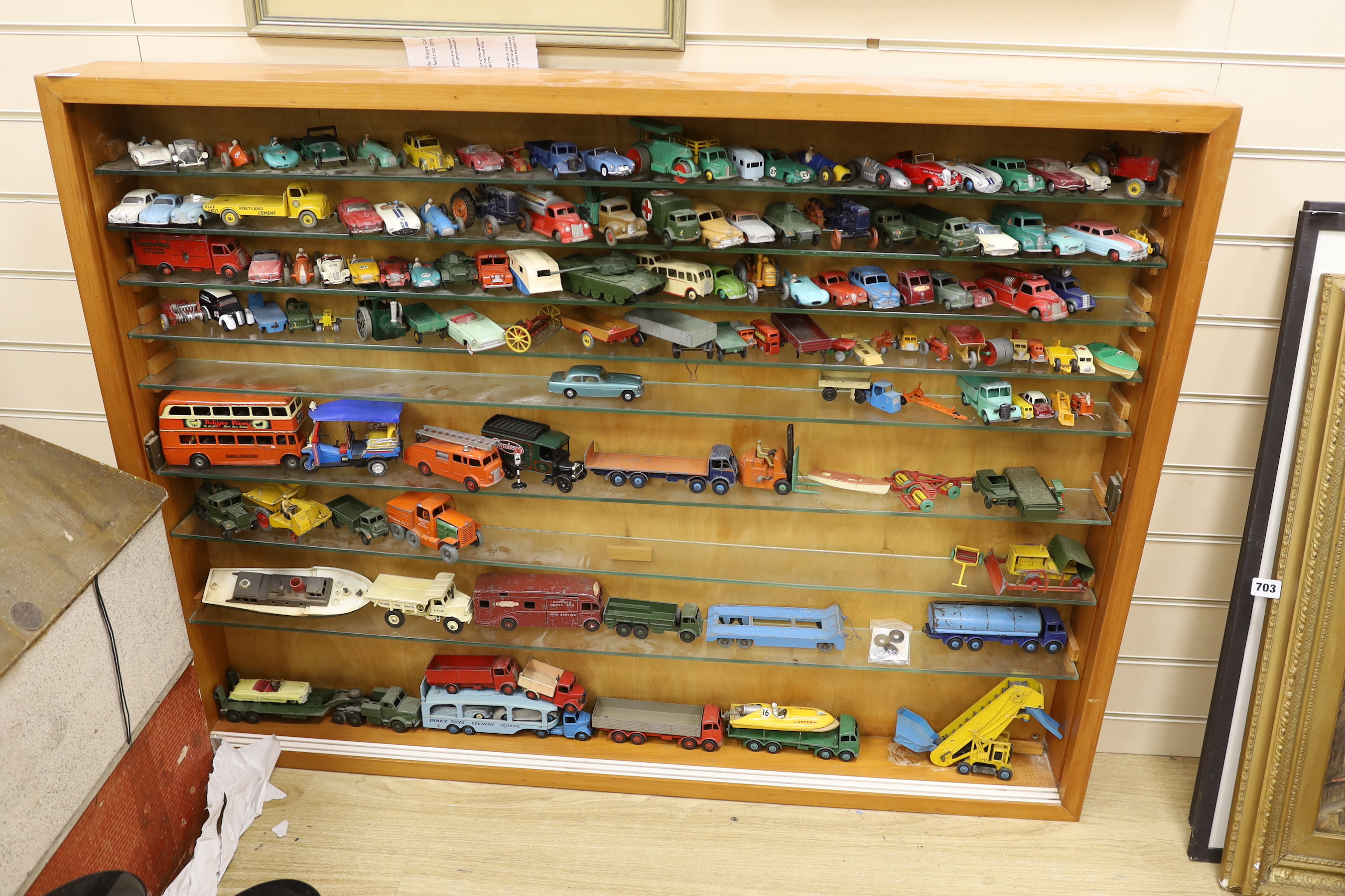 A collection of diecast vehicles in display case